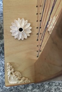 Baroque scrolls and larger daisies for the bottom sound holes